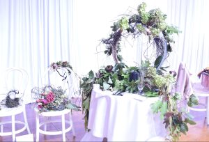 A wreath of greenery on a table