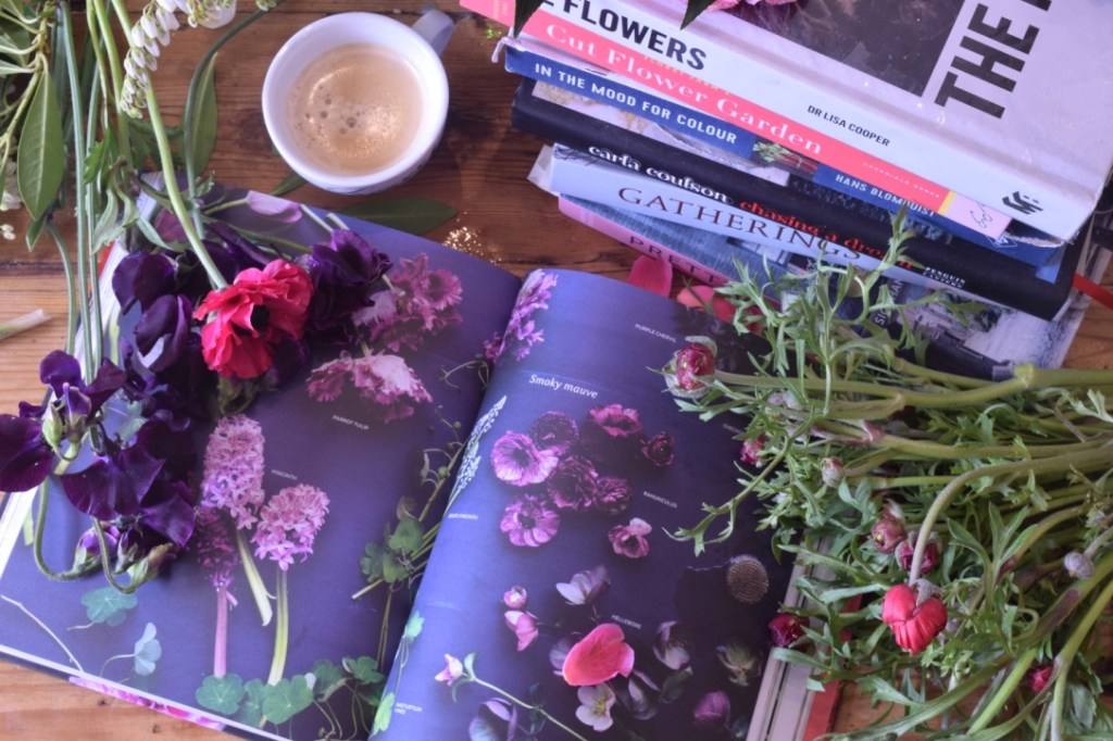 Stack of books surrounded by flowers